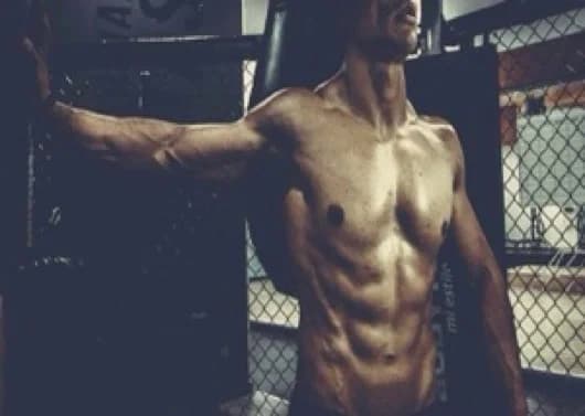 Trainer disinfecting weights before client session in Madhapur home gym