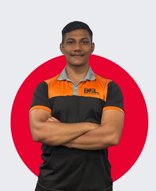 Male aerobic fitness instructor leading clients through high-intensity group cardio workout